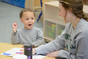 A Ready 4 Learning Student Works With A Children's Learning And Care Center Staff Member