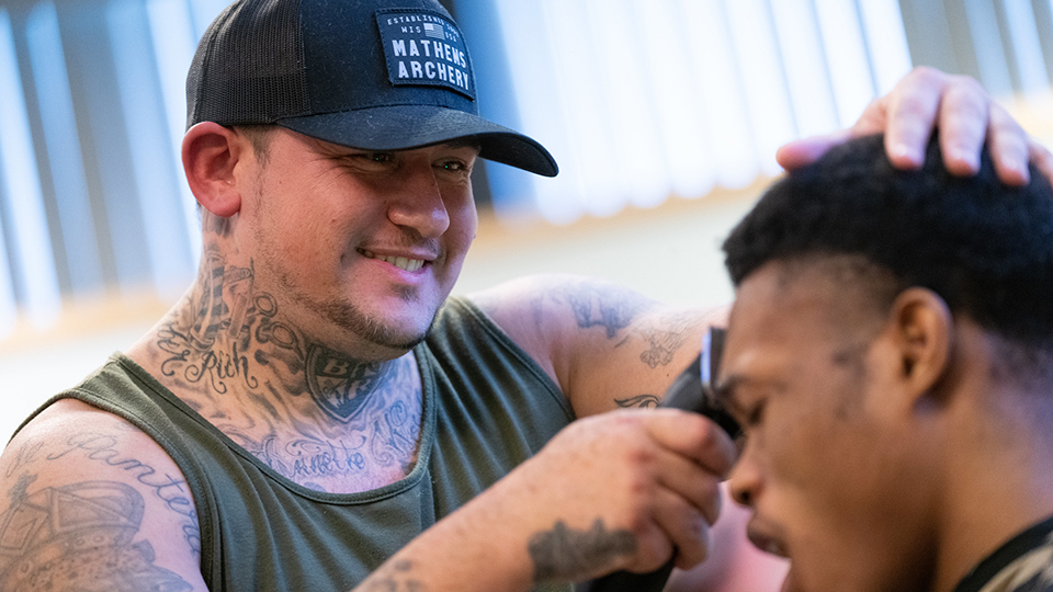 ‘Barber Rich’ delivers haircuts, life lessons during Titan Men of Diversity Week